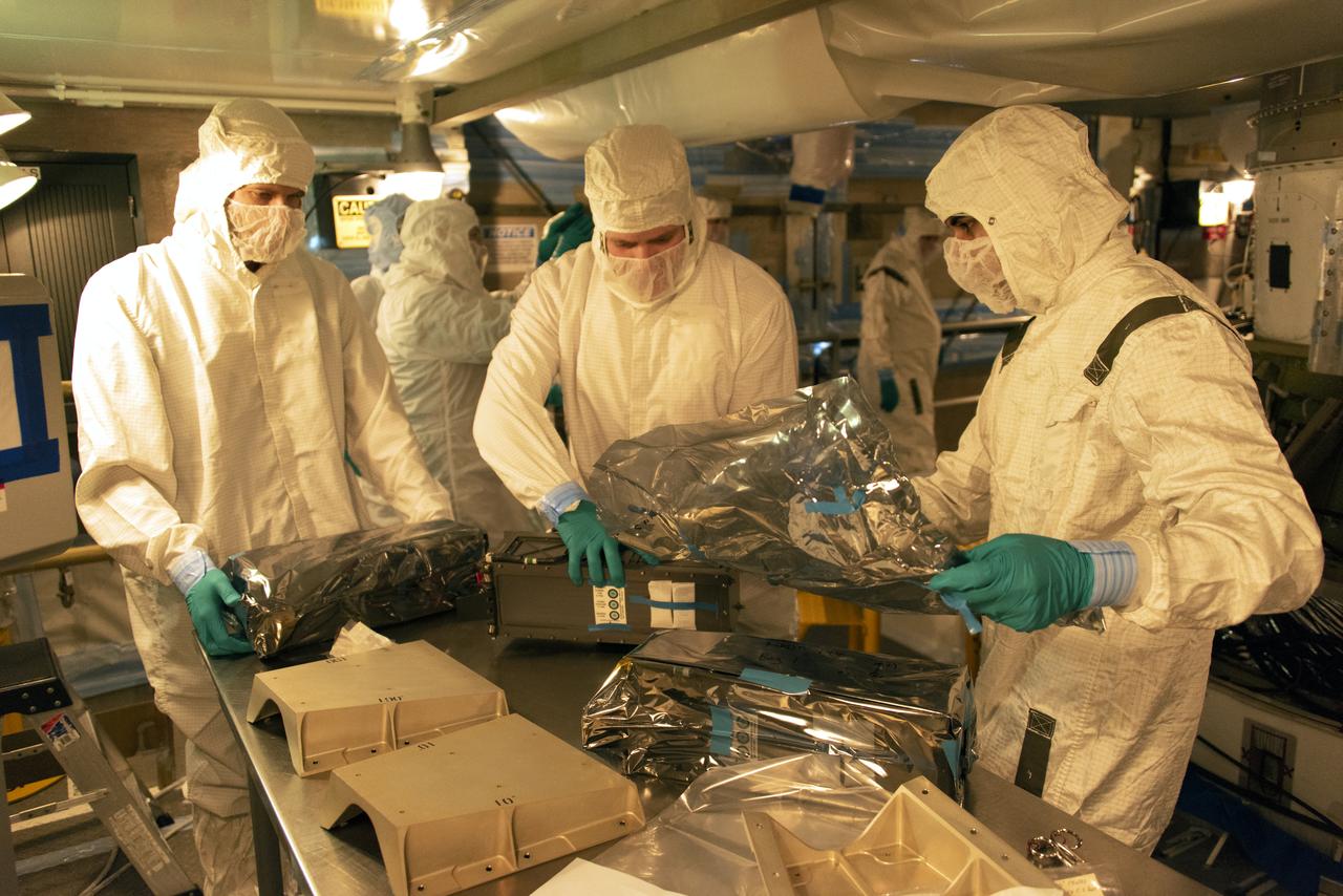 At Space Launch Complex 2 at Vandenberg Air Force Base in California, technicians prepare three poly picosatellite orbital deployers, or P-POD containers, with tiny satellites, called CubeSats inside, for installation on the direct mate adapter of the United Launch Alliance Delta II rocket, on Aug. 31, 2018. NASA's Ice, Cloud and land Elevation Satellite-2 (ICESat-2) is ready for launch aboard the final Delta II rocket. Launch is scheduled for Sept. 15, 2018. ICESat-2 will measure the height of a changing Earth, one laser pulse at a time, 10,000 laser pulses a second. The satellite will carry the Advanced Topographic Laser Altimeter System (ATLAS). ICESat-2 will help scientists investigate why, and how much our planet's frozen and icy areas, called the cryosphere, are changing in a warming climate.