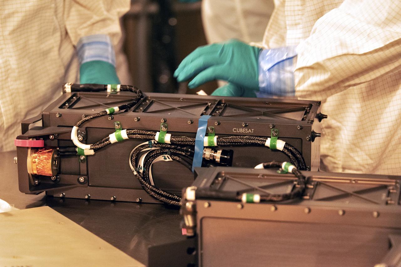 At Space Launch Complex 2 at Vandenberg Air Force Base in California, technicians prepare three poly picosatellite orbital deployers, or P-POD containers, with tiny satellites, called CubeSats inside, for installation on the direct mate adapter of the United Launch Alliance Delta II rocket, on Aug. 31, 2018. NASA's Ice, Cloud and land Elevation Satellite-2 (ICESat-2) is ready for launch aboard the final Delta II rocket. Launch is scheduled for Sept. 15, 2018. ICESat-2 will measure the height of a changing Earth, one laser pulse at a time, 10,000 laser pulses a second. The satellite will carry the Advanced Topographic Laser Altimeter System (ATLAS). ICESat-2 will help scientists investigate why, and how much our planet's frozen and icy areas, called the cryosphere, are changing in a warming climate.