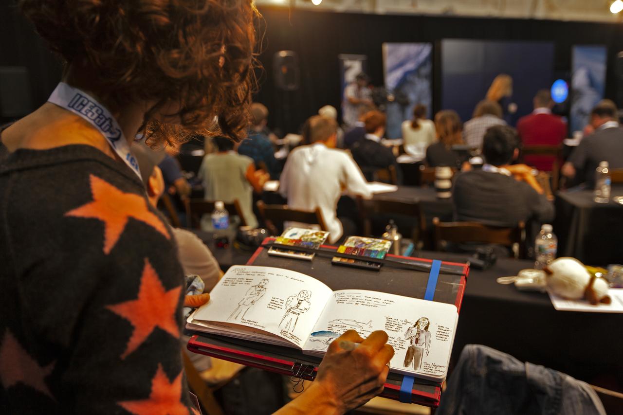 Social media participant sketches NASA and industry leaders speaking to members of the news media and social media participants during a prelaunch mission briefing for NASA's Ice, Cloud and land Elevation Satellite-2 (ICESat-2) on Sept. 13, 2018, at Vandenberg Air Force Base (VAFB) in California. ICESat-2 will launch aboard a United Launch Alliance Delta II, the rocket’s final mission, from Space Launch Complex 2 at VAFB. Launch is scheduled for 8:46 a.m. EDT (5:46 a.m. PDT). The satellite will measure the height of our changing Earth, one laser pulse at a time, 10,000 laser pulses per second. ICESat-2 will provide scientists with height measurements that create a global portrait of Earth's third dimension, gathering date that can precisely track changes of terrain, including glaciers, sea ice and forests.
