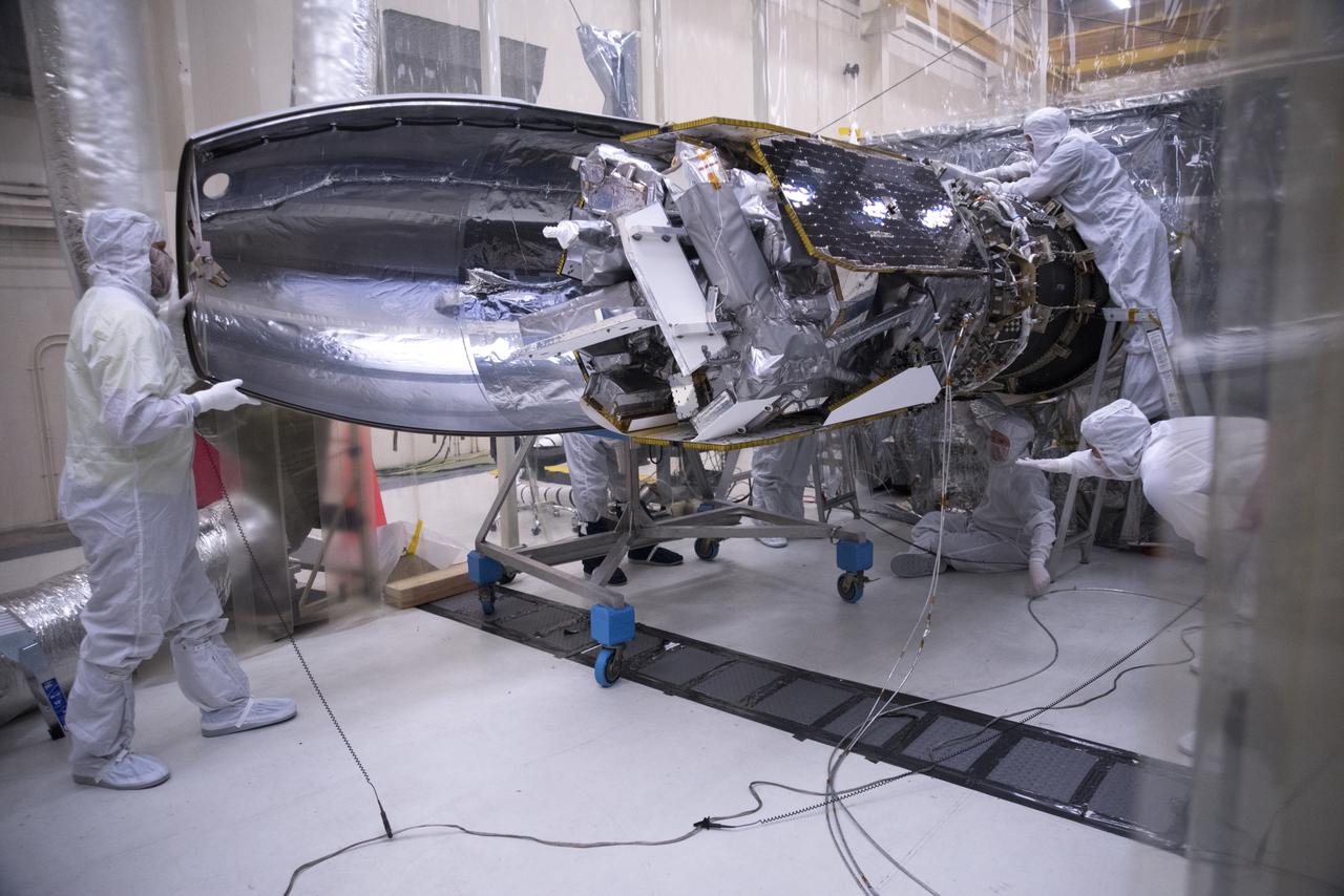 Inside a clean room in Building 1555 at Vandenberg Air Force Base in California, technicians install the first half of the Northrop Grumman Pegasus XL payload fairing around NASA's Ionospheric Connection Explorer (ICON) on Oct. 4, 2018. ICON is being prepared for its launch on the Pegasus XL, which is attached to the company's L-1011 Stargazer aircraft, from the Skid Strip at Cape Canaveral Air Force Station in Florida. Launch is scheduled for Oct. 26. ICON will study the frontier of space - the dynamic zone high in Earth's atmosphere where terrestrial weather from below meets space weather above. The explorer will help determine the physics of Earth's space environment and pave the way for mitigating its effects on our technology, communications systems and society.