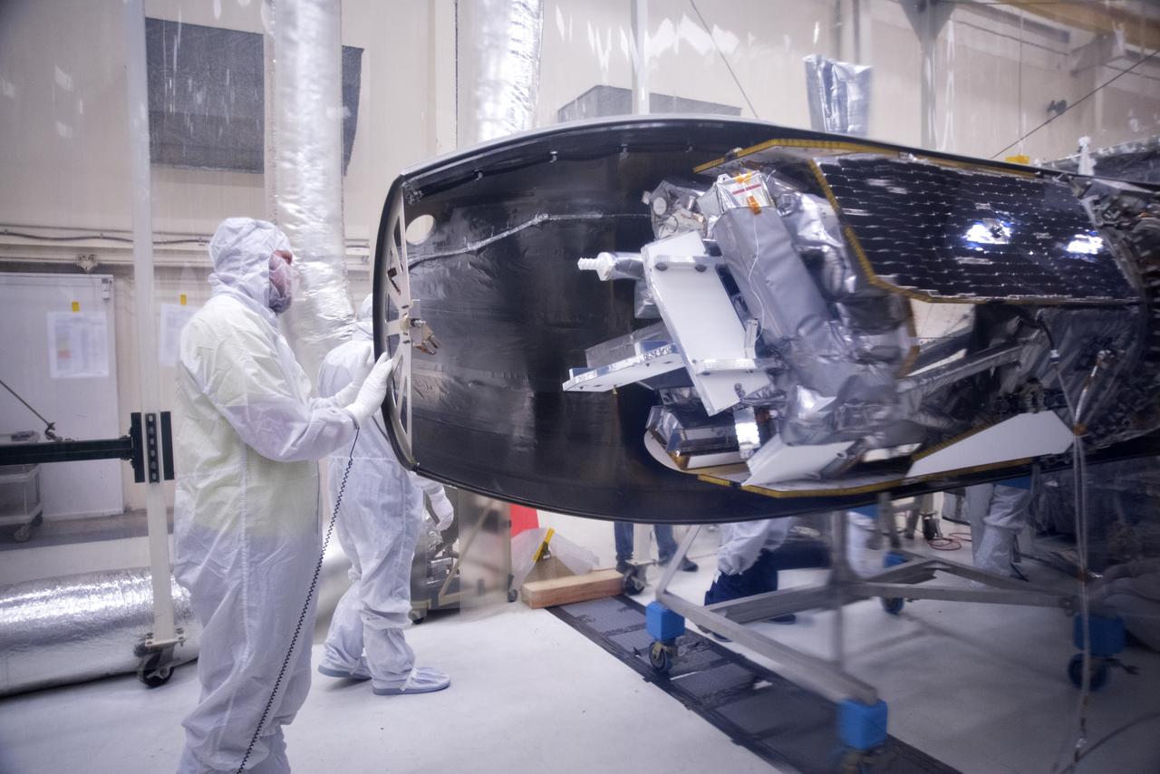 Inside a clean room in Building 1555 at Vandenberg Air Force Base in California, technicians install the first half of the Northrop Grumman Pegasus XL payload fairing around NASA's Ionospheric Connection Explorer (ICON) on Oct. 4, 2018. ICON is being prepared for its launch on the Pegasus XL, which is attached to the company's L-1011 Stargazer aircraft, from the Skid Strip at Cape Canaveral Air Force Station in Florida. Launch is scheduled for Oct. 26. ICON will study the frontier of space - the dynamic zone high in Earth's atmosphere where terrestrial weather from below meets space weather above. The explorer will help determine the physics of Earth's space environment and pave the way for mitigating its effects on our technology, communications systems and society.