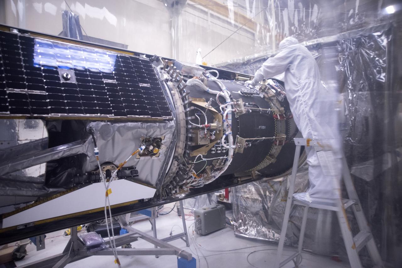 Inside a clean room in Building 1555 at Vandenberg Air Force Base in California, technicians install the first half of the Northrop Grumman Pegasus XL payload fairing around NASA's Ionospheric Connection Explorer (ICON) on Oct. 4, 2018. ICON is being prepared for its launch on the Pegasus XL, which is attached to the company's L-1011 Stargazer aircraft, from the Skid Strip at Cape Canaveral Air Force Station in Florida. Launch is scheduled for Oct. 26. ICON will study the frontier of space - the dynamic zone high in Earth's atmosphere where terrestrial weather from below meets space weather above. The explorer will help determine the physics of Earth's space environment and pave the way for mitigating its effects on our technology, communications systems and society.