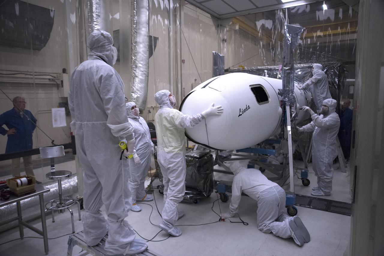 Inside a clean room in Building 1555 at Vandenberg Air Force Base in California, technicians install the second half of the Northrop Grumman Pegasus XL payload fairing around NASA's Ionospheric Connection Explorer (ICON) on Oct. 4, 2018. ICON is being prepared for its launch on the Pegasus XL, which is attached to the company's L-1011 Stargazer aircraft, from the Skid Strip at Cape Canaveral Air Force Station in Florida. Launch is scheduled for Oct. 26. ICON will study the frontier of space - the dynamic zone high in Earth's atmosphere where terrestrial weather from below meets space weather above. The explorer will help determine the physics of Earth's space environment and pave the way for mitigating its effects on our technology, communications systems and society.