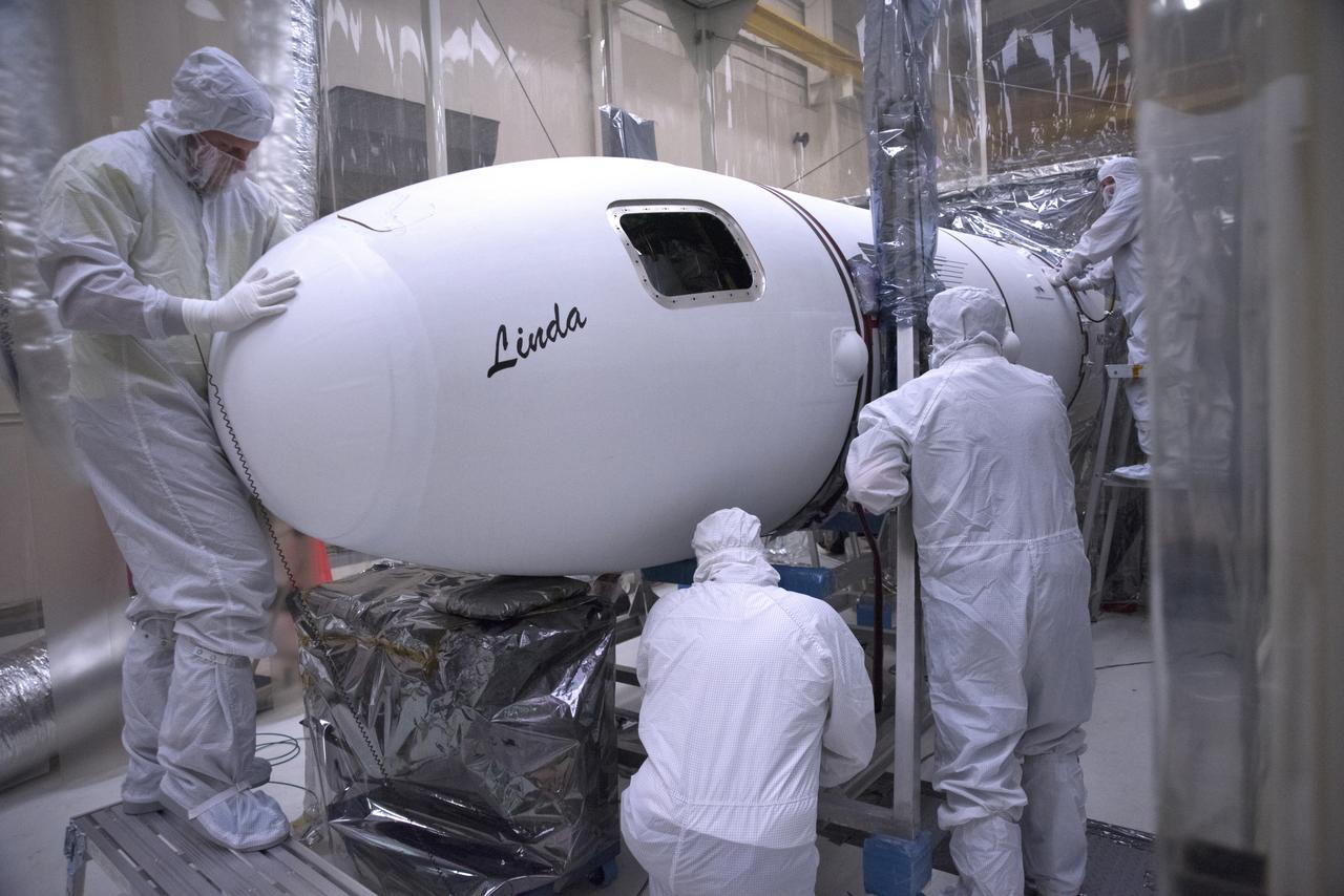 Inside a clean room in Building 1555 at Vandenberg Air Force Base in California, technicians install the second half of the Northrop Grumman Pegasus XL payload fairing around NASA's Ionospheric Connection Explorer (ICON) on Oct. 4, 2018. ICON is being prepared for its launch on the Pegasus XL, which is attached to the company's L-1011 Stargazer aircraft, from the Skid Strip at Cape Canaveral Air Force Station in Florida. Launch is scheduled for Oct. 26. ICON will study the frontier of space - the dynamic zone high in Earth's atmosphere where terrestrial weather from below meets space weather above. The explorer will help determine the physics of Earth's space environment and pave the way for mitigating its effects on our technology, communications systems and society.