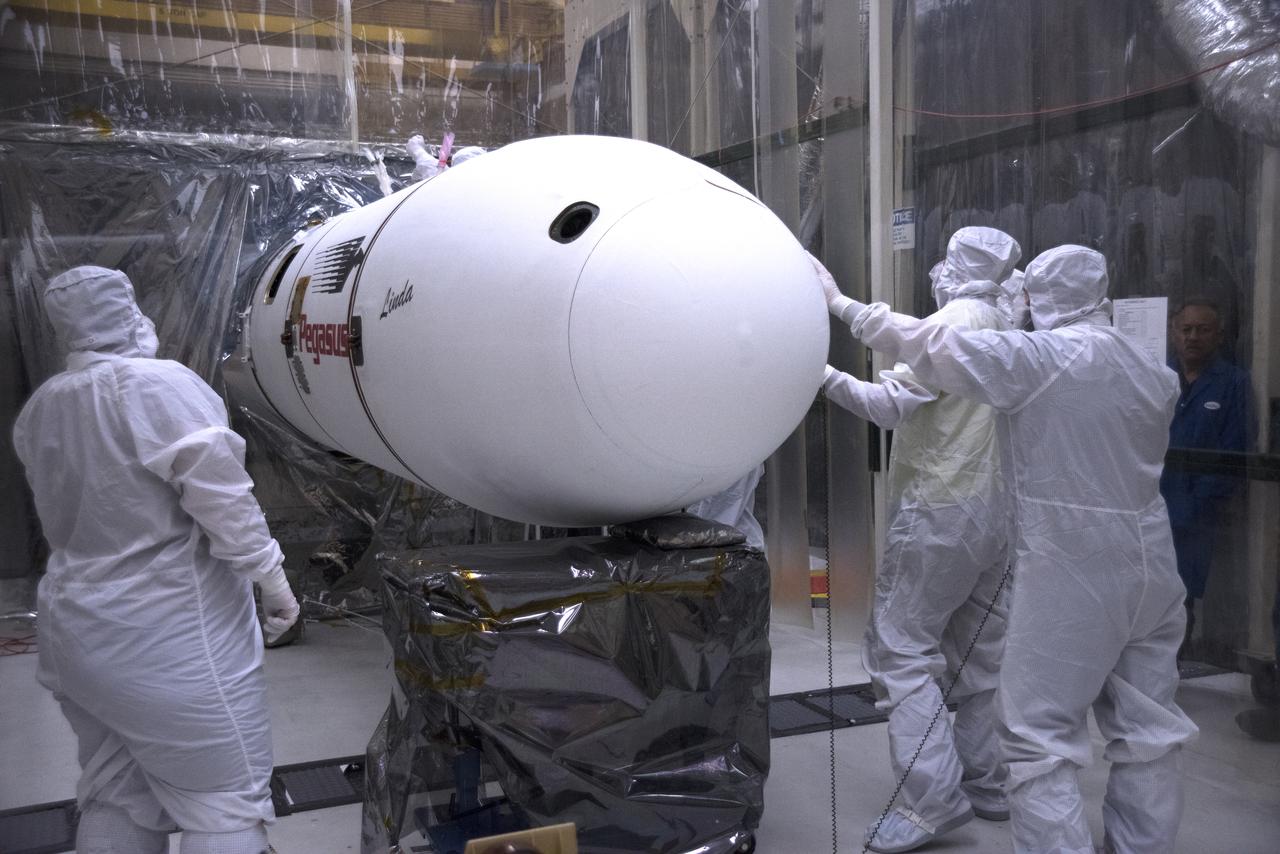 Inside a clean room in Building 1555 at Vandenberg Air Force Base in California, technicians complete installation of the second half of the Northrop Grumman Pegasus XL payload fairing around NASA's Ionospheric Connection Explorer (ICON) on Oct. 4, 2018. ICON is being prepared for its launch on the Pegasus XL, which is attached to the company's L-1011 Stargazer aircraft, from the Skid Strip at Cape Canaveral Air Force Station in Florida. Launch is scheduled for Oct. 26. ICON will study the frontier of space - the dynamic zone high in Earth's atmosphere where terrestrial weather from below meets space weather above. The explorer will help determine the physics of Earth's space environment and pave the way for mitigating its effects on our technology, communications systems and society.