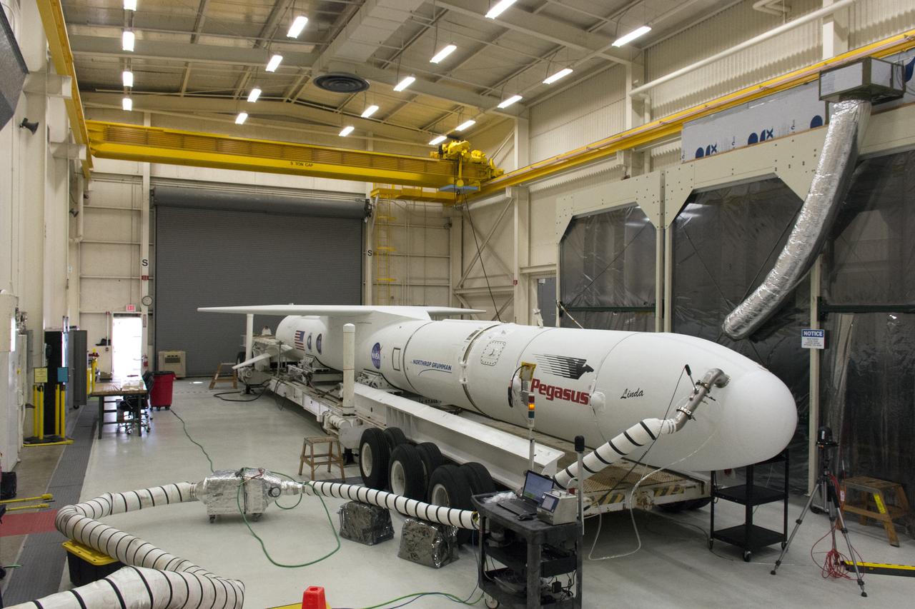 The Northrop Grumman Pegasus XL vehicle is being prepared for its move from Building 1555 to the hot pad at Vandenberg Air Force Base in California, on Oct. 14, 2018. NASA's Ionospheric Connection Explorer (ICON) is secured inside the rocket's payload fairing. The Pegasus XL rocket will be attached beneath the company's L-1011 Stargazer aircraft, and travel to the Skid Strip at Cape Canaveral Air Force Station in Florida. ICON will launch aboard the Pegasus XL rocket on Oct. 26, 2018, from the Skid Strip at the Cape.  ICON will study the frontier of space - the dynamic zone high in Earth's atmosphere where terrestrial weather from below meets space weather above. The explorer will help determine the physics of Earth's space environment and pave the way for mitigating its effects on our technology, communications systems and society.