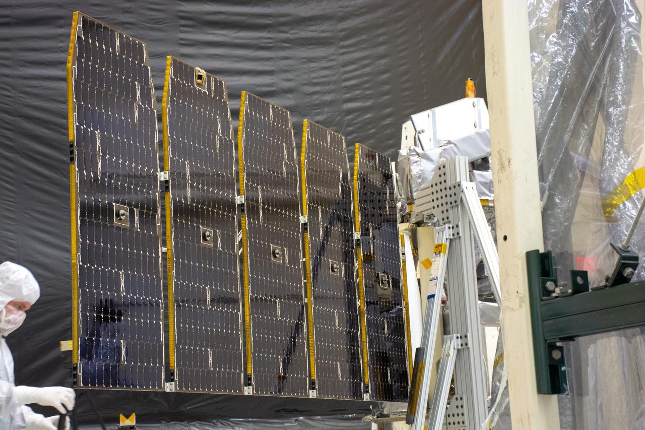 Technicians extend the solar array on NASA's Ionospheric Connection Explorer (ICON) during a deployment test inside Building 1555 at Vandenberg Air Force Base in California on Aug. 10, 2019. ICON will launch on a Pegasus XL rocket, attached beneath the company's L-1011 Stargazer aircraft, from the Skid Strip at Cape Canaveral Air Force Station in Florida. Launch is scheduled for Oct. 10. ICON will study the frontier of space - the dynamic zone high in Earth's atmosphere where terrestrial weather from below meets space weather above. The explorer will help determine the physics of Earth's space environment and pave the way for mitigating its effects on our technology and communications systems.