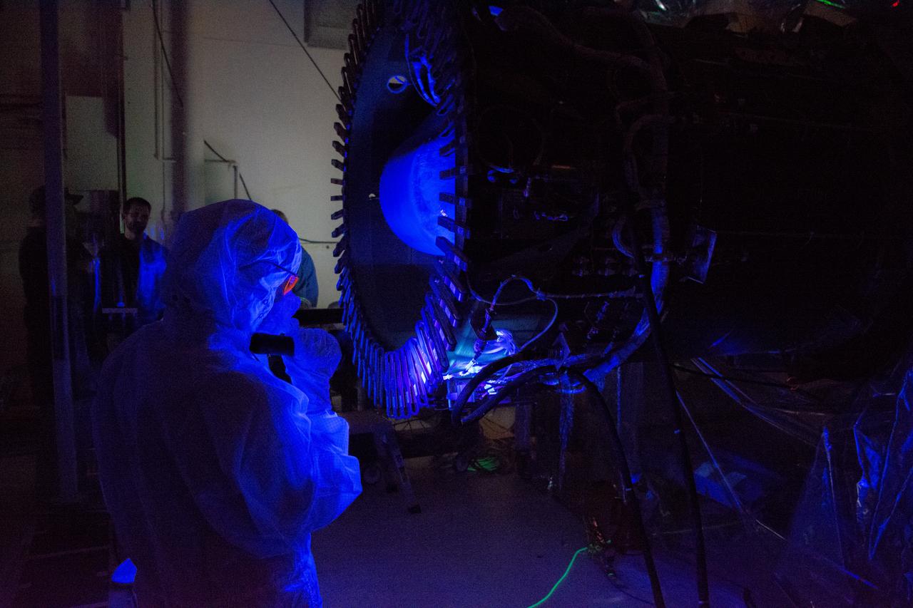 Technicians perform a black light inspection of the Northrop Grumman Pegasus XL rocket inside Building 1555 at Vandenberg Air Force Base in California, on Sept. 10, 2019, after NASA’s Ionospheric Connection Explorer (ICON) was attached to the rocket. The Pegasus port and starboard payload fairings will be installed around ICON. The Pegasus XL rocket, attached beneath the company's L-1011 Stargazer aircraft, will launch ICON from the Skid Strip at Cape Canaveral Air Force Station in Florida. Launch is scheduled for Oct. 9, 2019. ICON will study the frontier of space - the dynamic zone high in Earth's atmosphere where terrestrial weather from below meets space weather above. The explorer will help determine the physics of Earth's space environment and pave the way for mitigating its effects on our technology and communications systems.