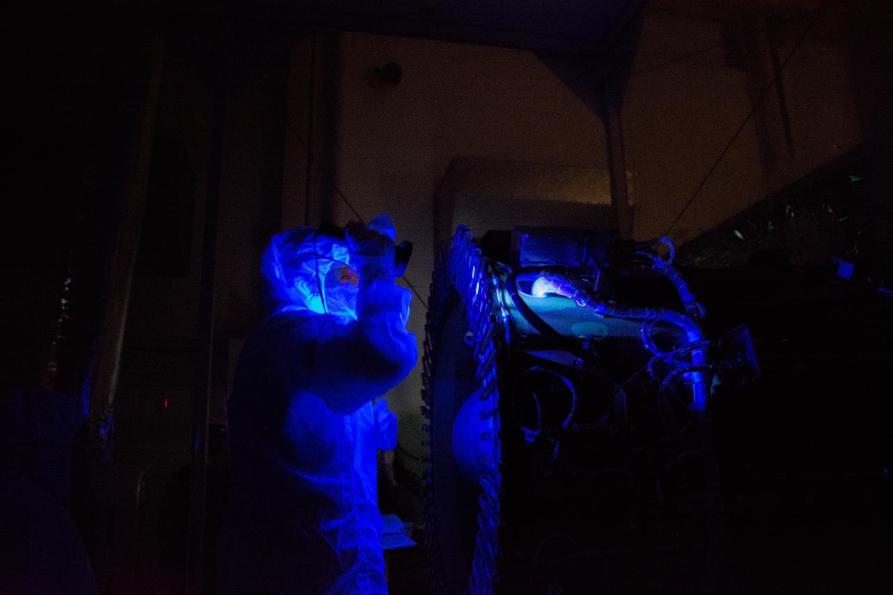 Technicians perform a black light inspection of the Northrop Grumman Pegasus XL rocket inside Building 1555 at Vandenberg Air Force Base in California, on Sept. 10, 2019, after NASA’s Ionospheric Connection Explorer (ICON) was attached to the rocket. The Pegasus port and starboard payload fairings will be installed around ICON. The Pegasus XL rocket, attached beneath the company's L-1011 Stargazer aircraft, will launch ICON from the Skid Strip at Cape Canaveral Air Force Station in Florida. Launch is scheduled for Oct. 9, 2019. ICON will study the frontier of space - the dynamic zone high in Earth's atmosphere where terrestrial weather from below meets space weather above. The explorer will help determine the physics of Earth's space environment and pave the way for mitigating its effects on our technology and communications systems.