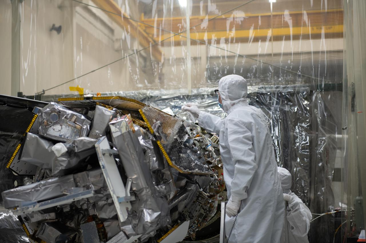 Technicians prepare to install the starboard side of the Northrop Grumman Pegasus XL rocket’s payload fairing around NASA's Ionospheric Connection Explorer (ICON) inside Building 1555 at Vandenberg Air Force Base in California on Sept. 17, 2019. ICON launched on the Pegasus XL rocket, attached beneath the company's L-1011 Stargazer aircraft, on Oct. 10, 2019, after takeoff from the Skid Strip at Cape Canaveral Air Force Station in Florida. ICON will study the frontier of space - the dynamic zone high in Earth's atmosphere where terrestrial weather from below meets space weather above. The explorer will help determine the physics of Earth's space environment and pave the way for mitigating its effects on our technology, communications systems and society.