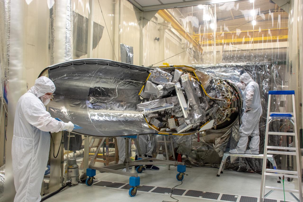 Technicians install the starboard side of the Northrop Grumman Pegasus XL rocket’s payload fairing around NASA's Ionospheric Connection Explorer (ICON) inside Building 1555 at Vandenberg Air Force Base in California on Sept. 17, 2019. ICON launched on the Pegasus XL rocket, attached beneath the company's L-1011 Stargazer aircraft, on Oct. 10, 2019, after takeoff from the Skid Strip at Cape Canaveral Air Force Station in Florida. ICON will study the frontier of space - the dynamic zone high in Earth's atmosphere where terrestrial weather from below meets space weather above. The explorer will help determine the physics of Earth's space environment and pave the way for mitigating its effects on our technology, communications systems and society.