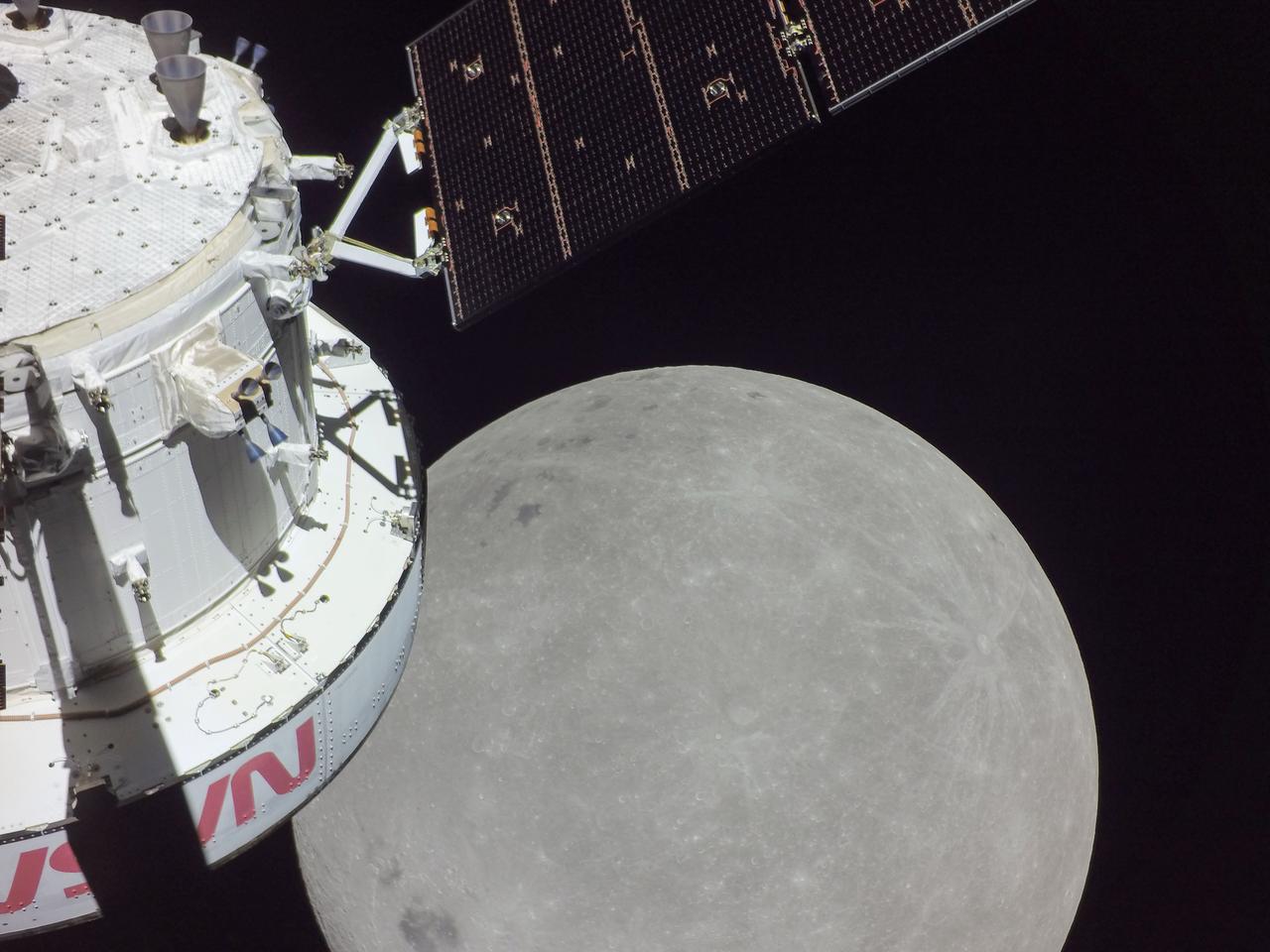 (Nov. 21, 2022) A portion of the Moon looms large just beyond the Orion spacecraft in this image taken on the sixth day of the Artemis I mission by a camera on the tip of one of Orion’s solar arrays. The spacecraft entered the lunar sphere of influence Sunday, Nov. 20, making the Moon, instead of Earth, the main gravitational force acting on the spacecraft. On Monday, Nov. 21, it came within 80 miles of the lunar surface, the closest approach of the uncrewed Artemis I mission, before moving into a distant retrograde orbit around the Moon. The darkest spot visible near the middle of the image is Mare Orientale.