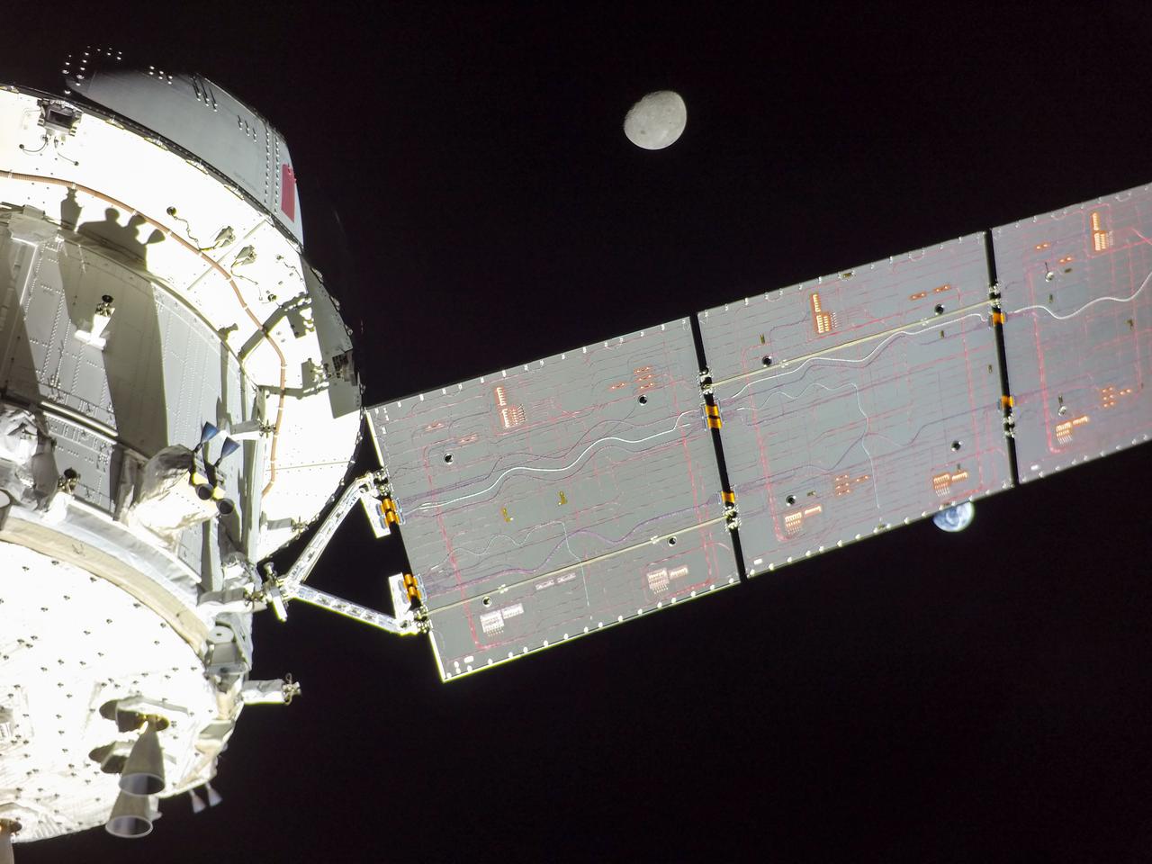 art001e001713 (Nov. 29, 2022) Orion’s solar arrays split the difference between Earth and the Moon on flight day 14 of the Artemis I mission in this image captured by a camera on the tip of one of the spacecraft’s four solar arrays.