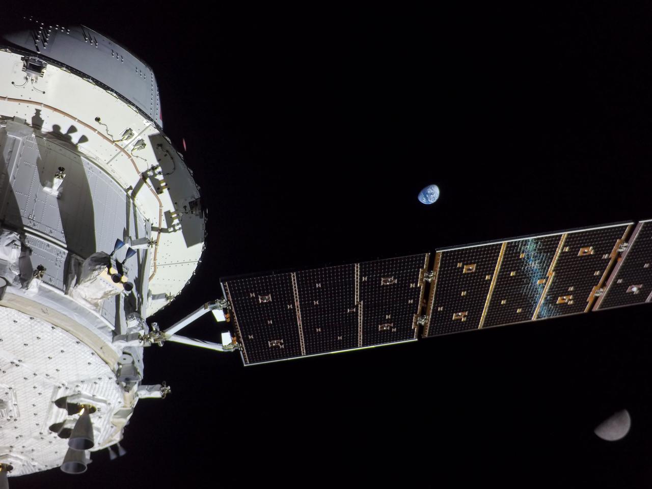 art001e001822 (Nov. 28, 2022) On flight day 13 of the Artemis I mission, Orion captured this view of Earth and the Moon on either sides of one of the spacecraft’s four solar arrays.