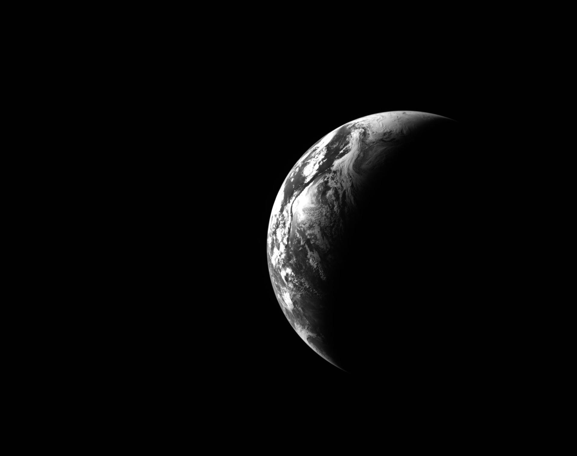 art002e000181 (April 3, 2026) - This black and white image of Earth was captured by the optical navigation sensor on the exterior of the Orion spacecraft on the first day of the Artemis II mission, as the four astronauts inside were traveling farther than any humans have ventured in more than 50 years. Credit: NASA