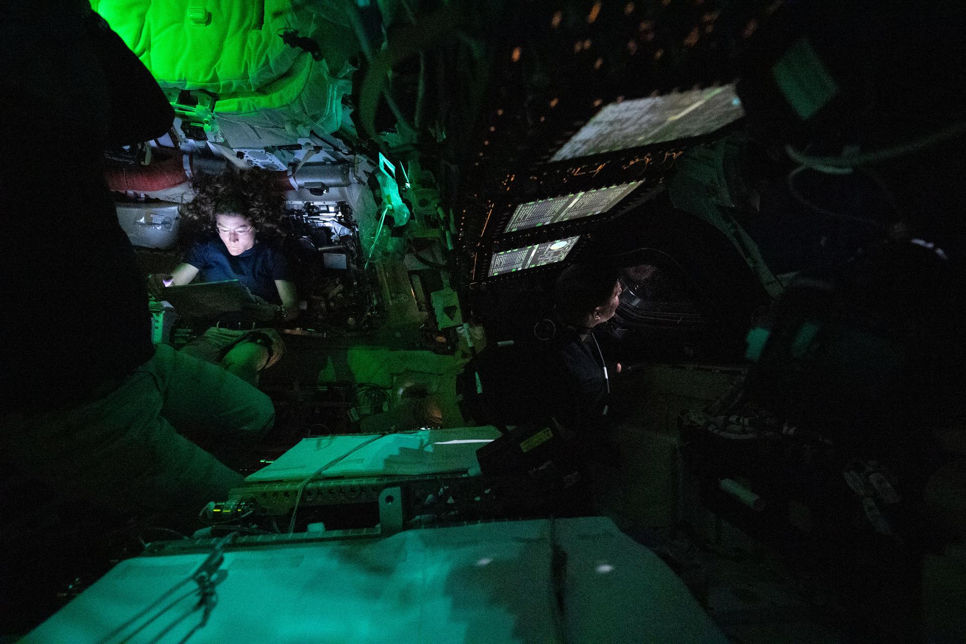 art002e004440 (April 3, 2026) - NASA astronaut Christina Koch is illuminated by a screen inside the darkened Orion spacecraft on...