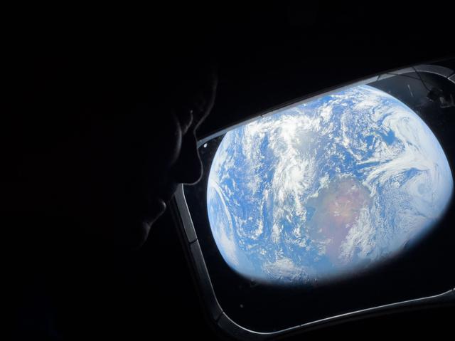 NASA astronaut and Artemis II Commander Reid Wiseman peers...