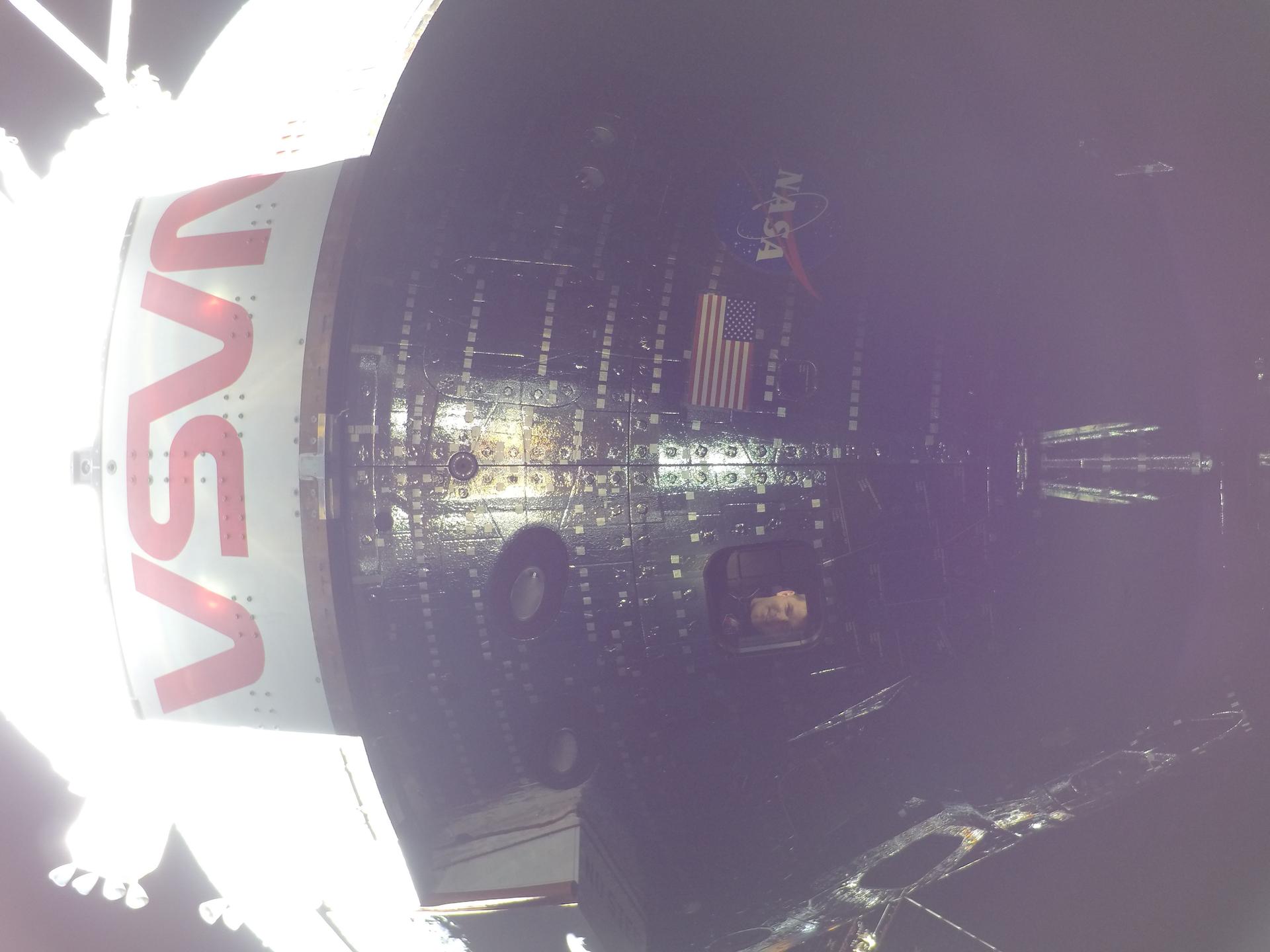 art002e009008 (April 4, 2026) - Artemis II Mission Specialist Jeremy Hansen is seen through a window of the Orion spacecraft...