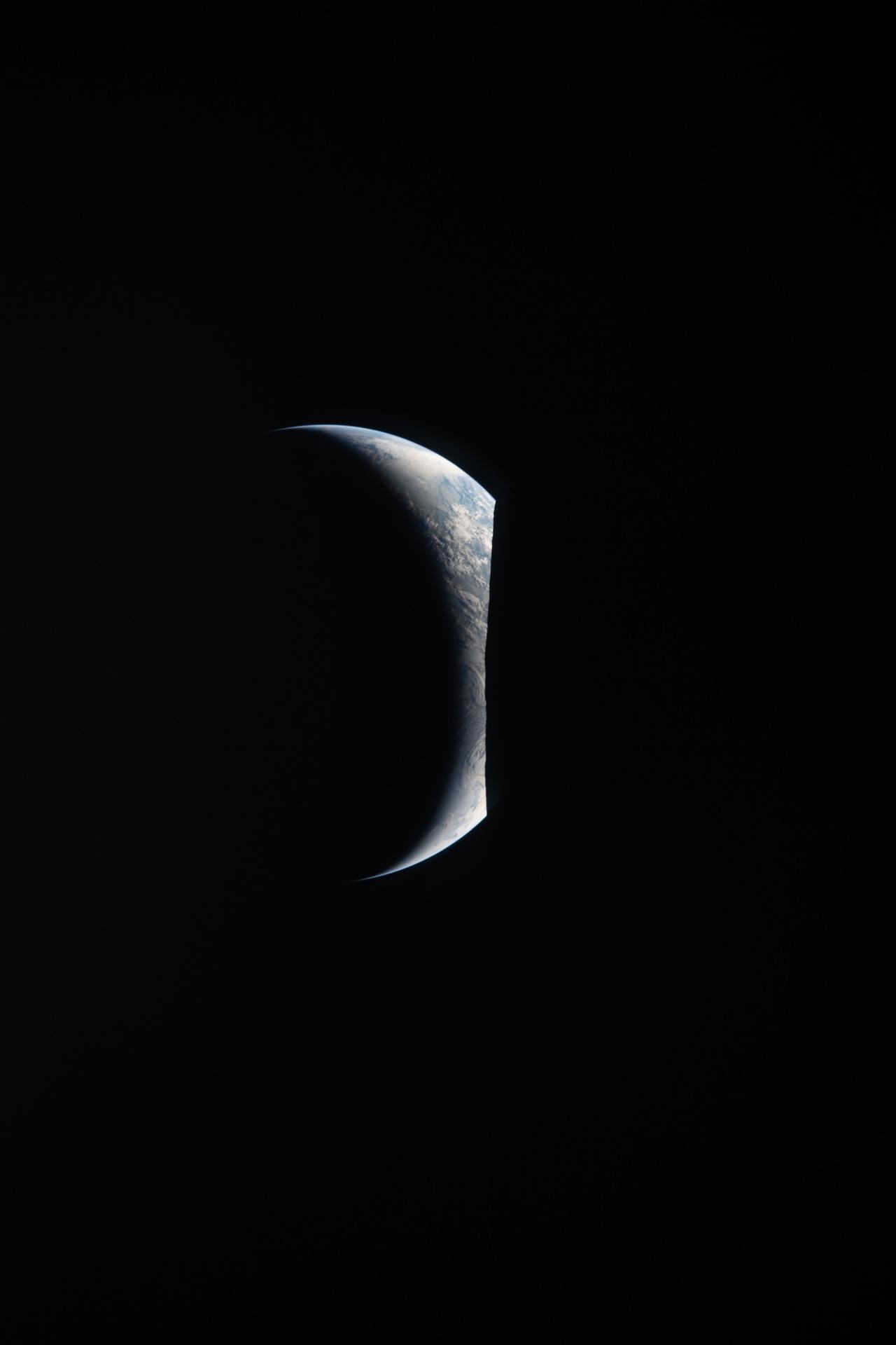 art002e009280 (April 6, 2026) – Earthrise captured through the Orion spacecraft window at 7:22 p.m. ET during the Artemis II...
