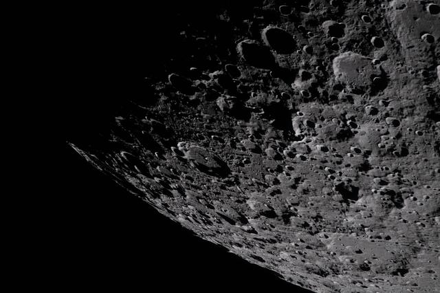 Captured by the Artemis II crew, the heavily cratered terrain...