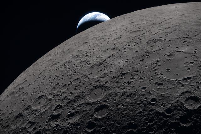 The lunar surface fills the frame in sharp detail, as seen...