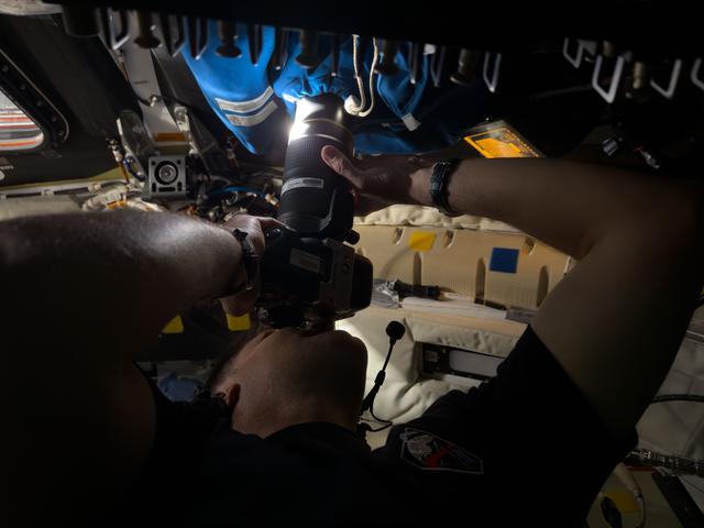 Astronaut Jeremy Hansen captures an image through the camera...