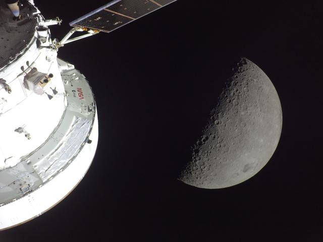 NASA’s Orion spacecraft is seen in the foreground, lit up by...