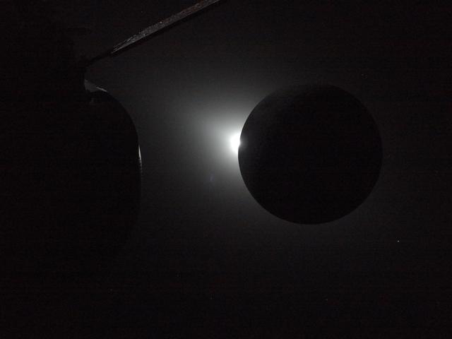 The Sun is rising at the left edge of the Moon, ending a...