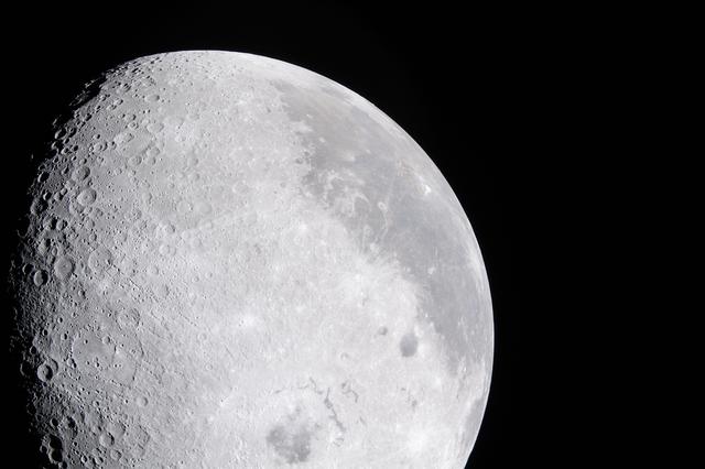 A bright portion of the Moon is visible in this image. If you...