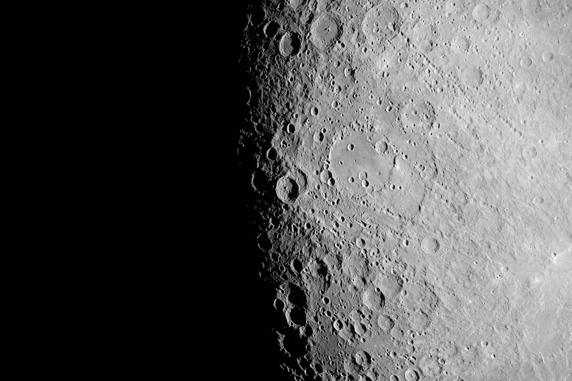 art002e010032 (April 6, 2026) – The Artemis II crew captured this view near Hertzsprung and Vavilov craters along the lunar terminator, the boundary between the Moon’s illuminated and shadowed regions. The low Sun angle casts deep shadows across the densely cratered terrain, sharply defining crater rims, walls, and other surface features as they emerge from darkness. Credit: NASA