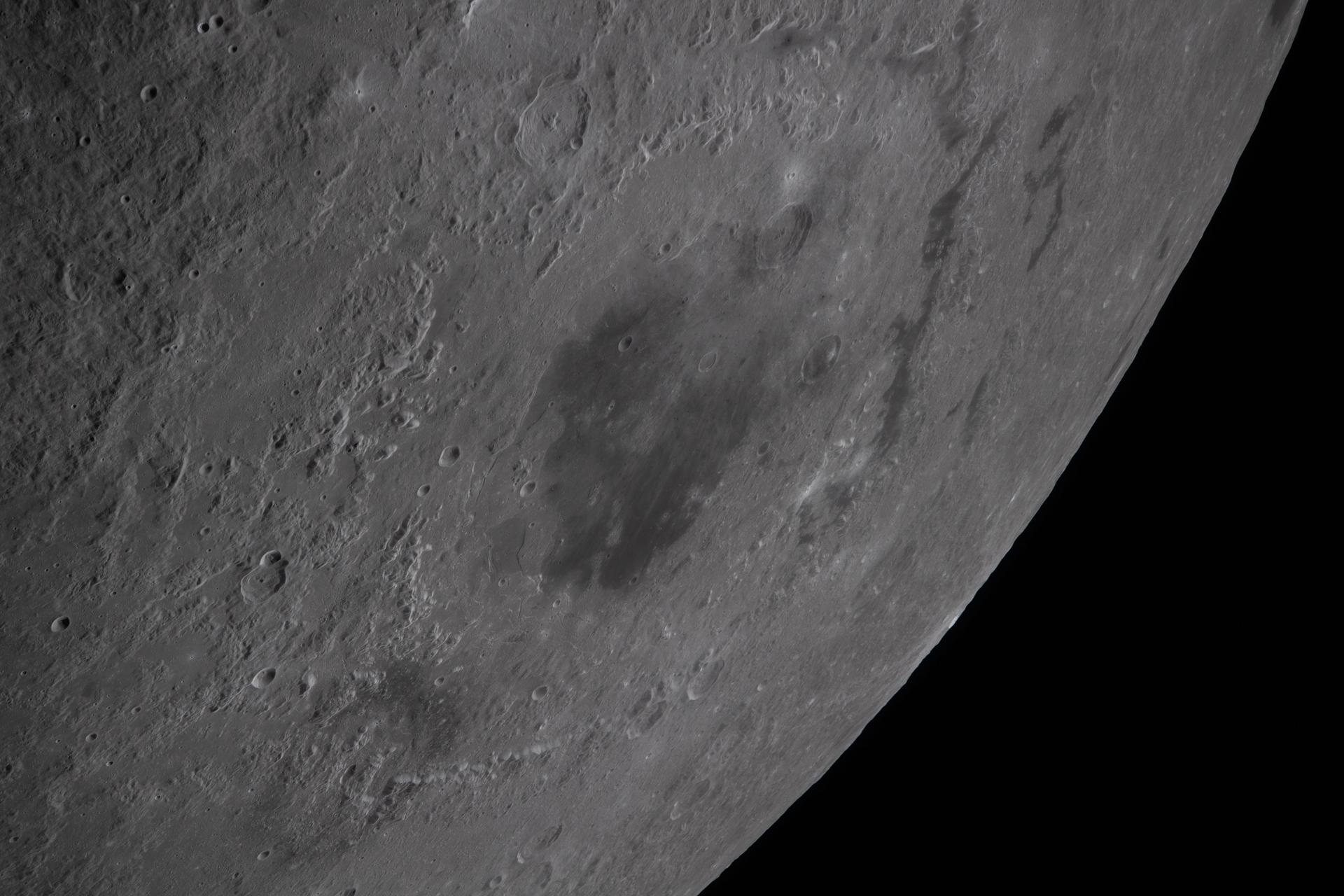 art002e010230 (April 6, 2026) – The Artemis II crew captured this angled view of the Moon’s Orientale basin during their lunar flyby. Darker material within the basin contrasts with the brighter surrounding terrain, while shadows and variations in illumination reveal ridges, craters, and other surface features. Images of Orientale acquired under different viewing and lighting angles support photometric studies of how the lunar surface reflects light. Credits: NASA