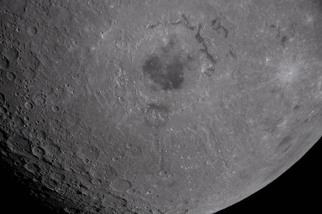 The lower half of the Moon hangs suspended in time in this...
