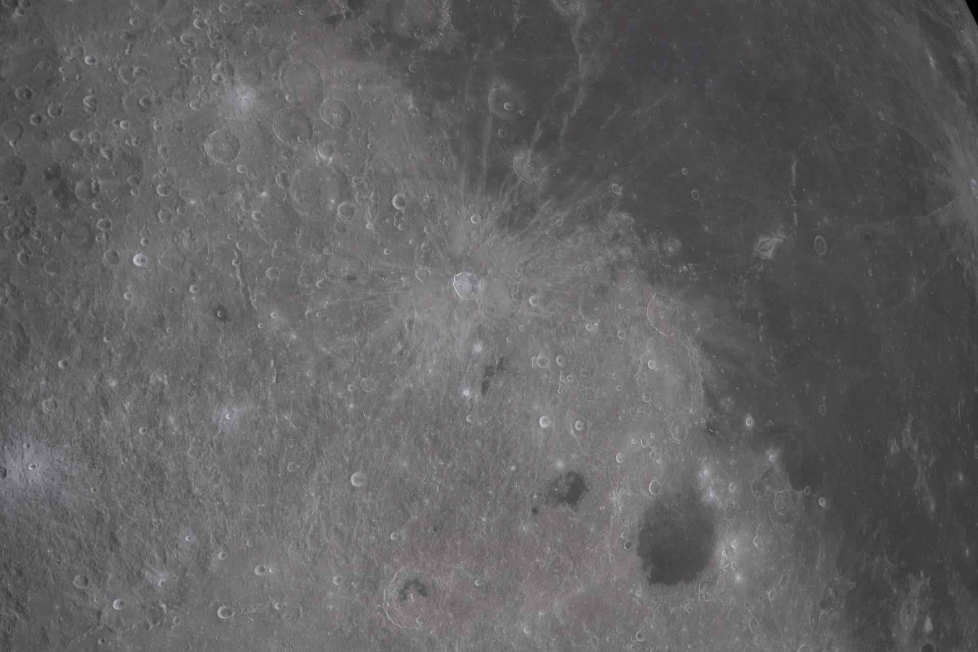 art002e012216 (April 6, 2026) – The Artemis II crew captured this view across the transition between the Moon’s near side and far side during their lunar flyby. Bright, densely cratered terrain contrasts with darker volcanic plains, while lighter streaks and markings extend across portions of the surface. The image includes the Reiner Gamma region, known for its distinctive bright, swirling surface patterns. Credit: NASA