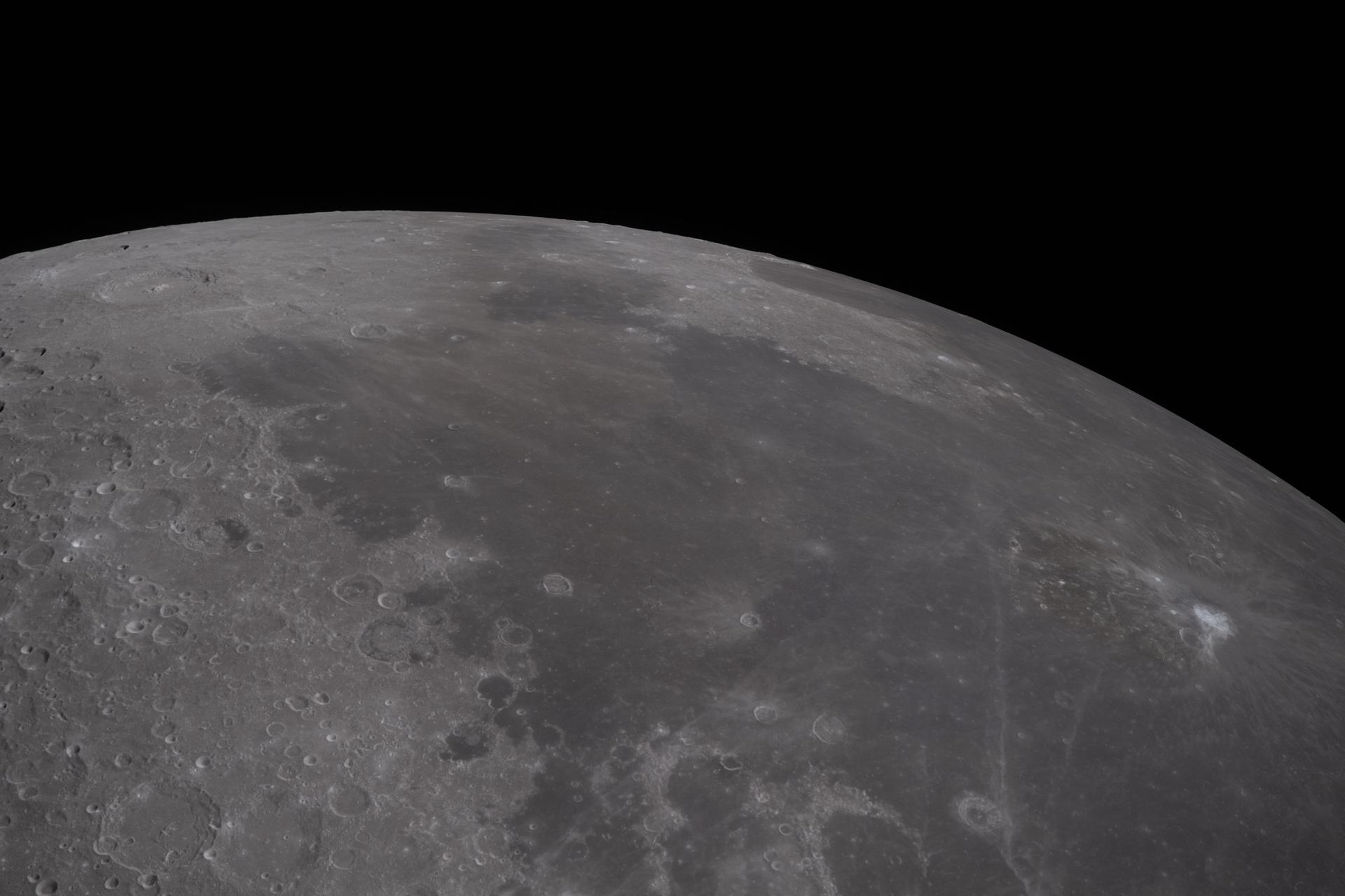art002e012228 (April 6, 2026) – The Artemis II crew captured this view while observing volcanic terrain across the Moon’s near side-far side transition. The astronauts noted differences in color and brightness among volcanic regions, including darker terrain at Grimaldi and Orientale and variations in hue near the Aristarchus Plateau and Oceanus Procellarum. These observations provide scientists with additional context for studying differences in the composition and geologic history of the Moon’s volcanic terrain. Credit: NASA