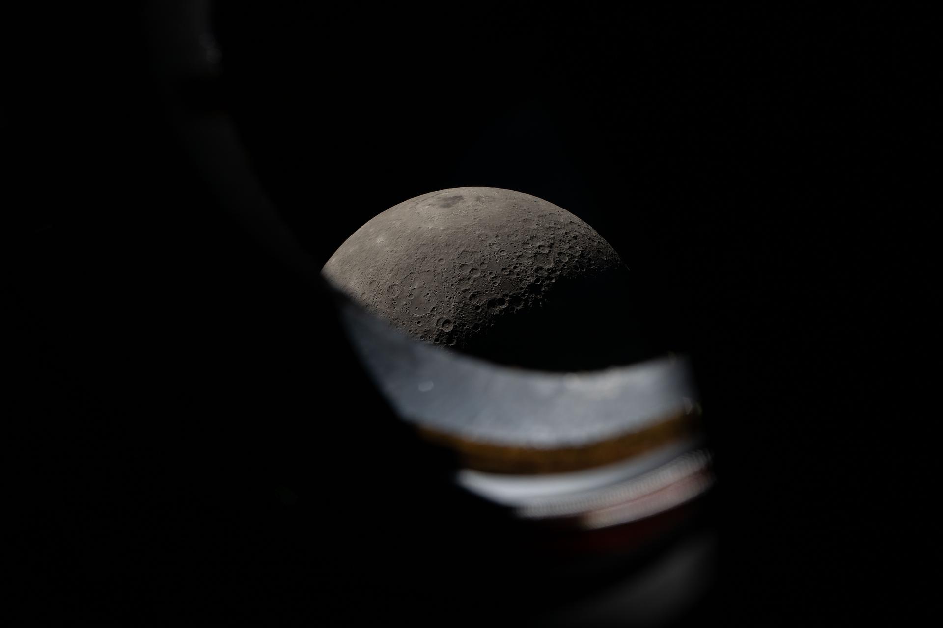 art002e012278 (April 6, 2026) - The Moon seen peeking above the window sill of the Orion spacecraft during the Artemis...