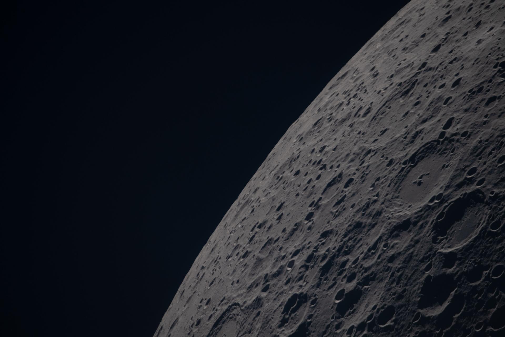 art002e012702 (April 6, 2026) – Poynting crater and Keeler crater are visible side by side in the lower right portion of this image of the Moon’s far side highlands. Poynting, positioned above, is a large impact crater with a well-defined rim and relatively smooth interior, indicative of material that has settled following the initial impact. Just below it, Keeler crater appears slightly smaller, with a sharply outlined rim and a more textured interior shaped by subsequent impacts and ejecta. Both features lie within the densely cratered far side highlands, preserving a record of ancient impacts that have shaped the lunar surface over billions of years.