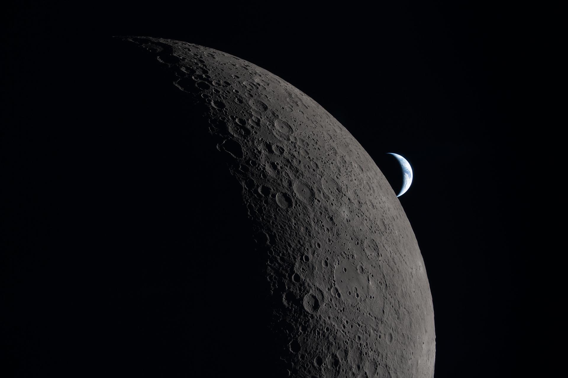 art002e021169 (April 6, 2026) - This photo of a crescent Moon and crescent Earth was taken by an Artemis II astronaut during lunar flyby on flight day 6. This captures one of the final moments before their loss of signal with Earth as the Orion spacecraft flew around the far side of the Moon, reemerging and regaining contact approximately 40 minutes later.