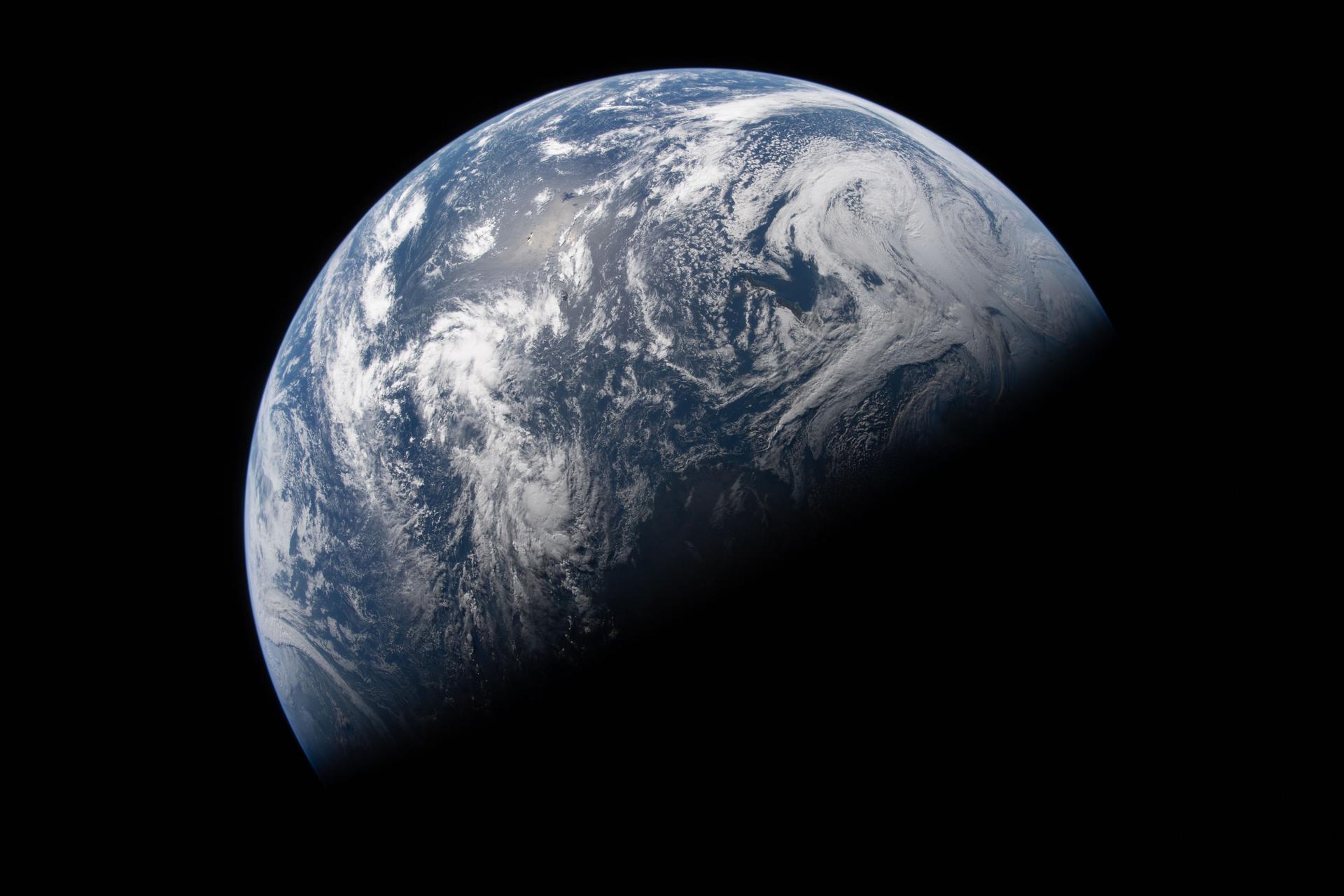art002e023506 (April 2, 2026) - Earth is illuminated against the blackness of space in this photo taken by an Artemis II...