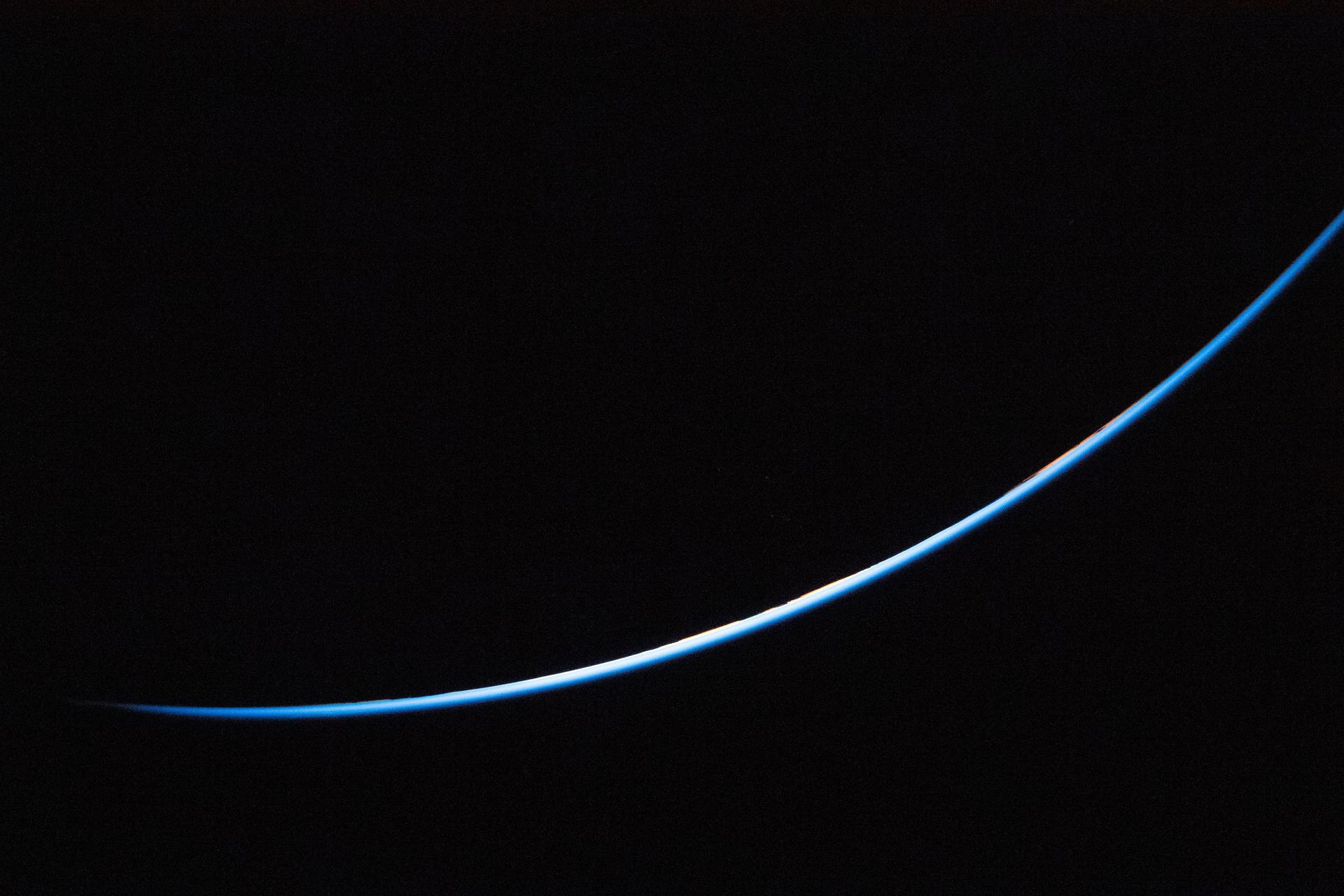 art002e023710 (April 3, 2026) - A sliver of the edge of Earth is brightly illuminated against the vast darkness of...