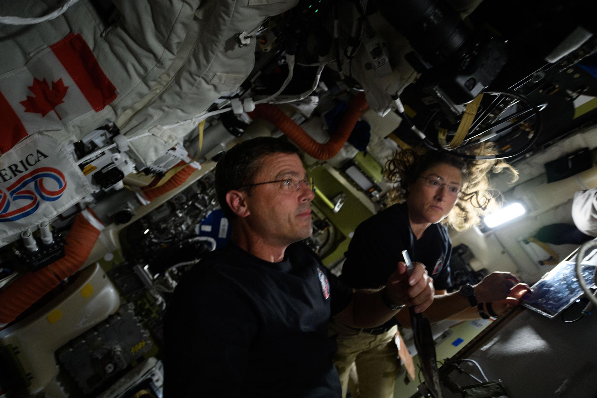 art002e026139 (April 7, 2026) - NASA astronauts Reid Wiseman and Christina Koch are captured in a blurry snap on the seventh day of the Artemis II mission. On this day, the crew officially began their journey home after flying around the Moon one day prior. In this photo, Reid Wiseman holds a drink bag equipped with a straw for easy use in microgravity. Credit: NASA