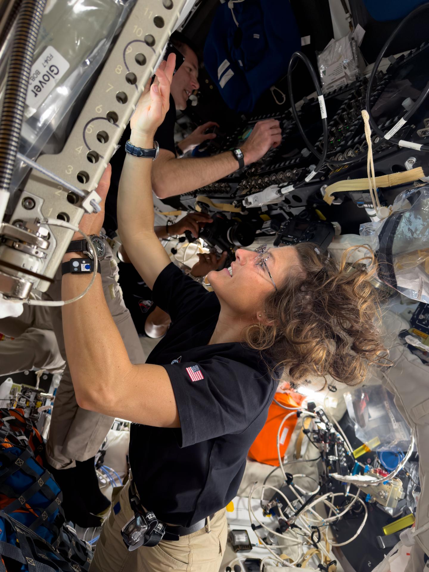 art002e042105 (April 7, 2026) - NASA astronaut and Artemis II mission specialist Christina Koch inspects seat hardware inside the Orion spacecraft, while CSA (Canadian Space Agency) astronaut and mission specialist Jeremy Hansen monitors the crew displays. Credit: NASA