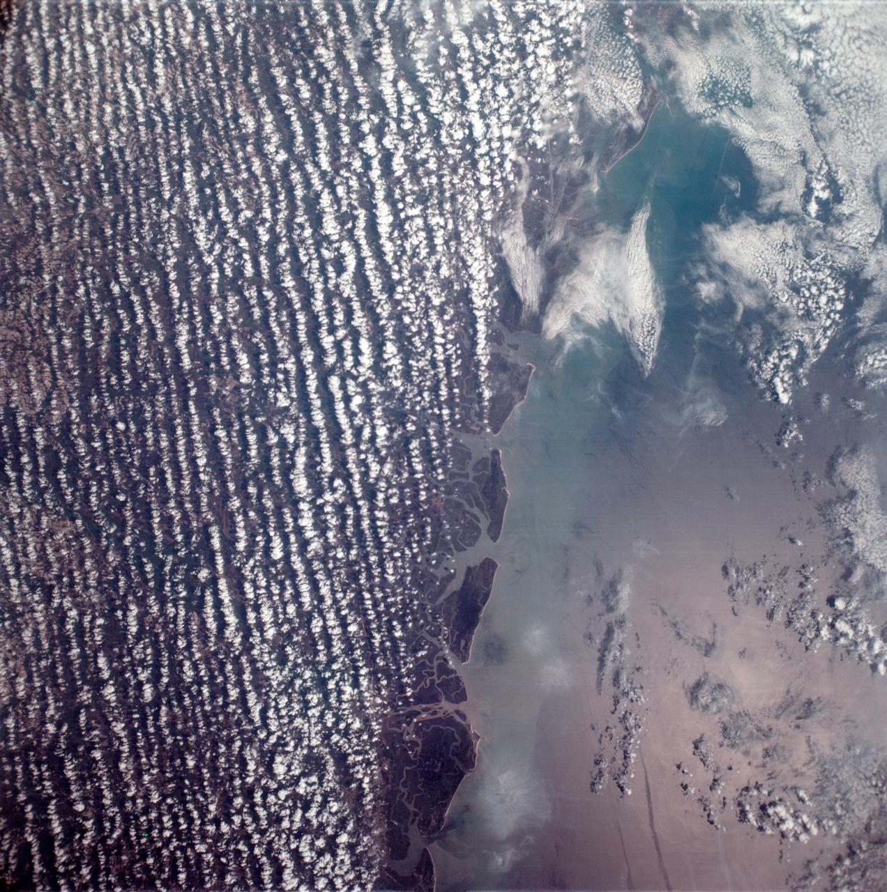 AS6-02-1485 (4 April 1968) --- View of the east coast of the United States as photographed from the National Aeronautics and Space Administration's unmanned Apollo 6 (Spacecraft 020/Saturn 502) space mission. This photograph was taken during a pass over Georgia, between Savannah and Brunswick. Altitude of the spacecraft was 100 nautical miles. Numerous jet aircraft contrails can be seen over the Atlantic Ocean. Sun glint on the surface of the ocean permits oceanographers to determine conditions of the water. This photograph was taken April 4, 1968, three hours and 14 minutes after liftoff, using Eastman Kodak SO-121 high resolution aerial Ektachrome film (exposure setting f/5.6 at 1/500 second), in a J. A. Maurer model 220G camera.