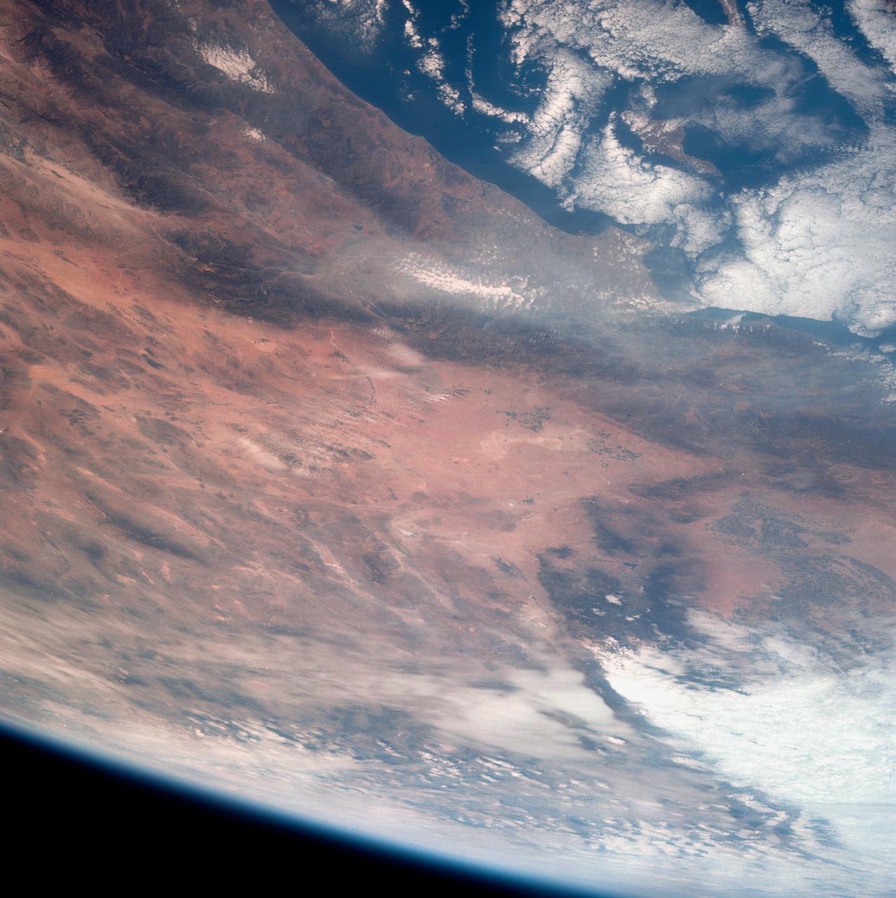 This view of southern California as seen from the Apollo 7 spacecraft during its 18th revolution of the earth. Photographed from an altitude of 124 nautical miles. The coast of California can be seen from Point Mugu southward to Oceanside. Santa Catalina can be seen below the off shore clouds. Details of the Los Angeles area are obscured by pollution which extends from Banning westard for 100 miles to beyond Malibu. In the upper portion of the photograph can be seen (left to right) the San Joaquin Valley beyond Bakersfield, the Techachapi Mountains, the Sierra Nevada, Owens Valley, Death Valley and the Mojave Desert.