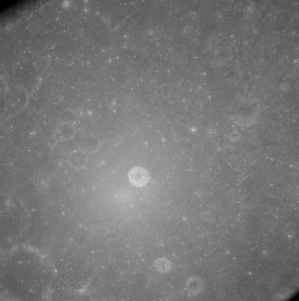 AS08-12-2148 (21-27 Dec. 1968) --- View of the lunar surface as photographed from the Apollo 8 spacecraft. Zero-phase bright spot. With near-vertical sun illumination, topographical detail is washed out and differences in surface brightness are accentuated. The numerous small bright-halo craters become conspicuous. A few larger craters have extremely bright inner walls that are commonly streaked by darker material. The bright glow near the conspicuous bright-walled crater is a halo that surrounds the position of the spacecraft shadow.