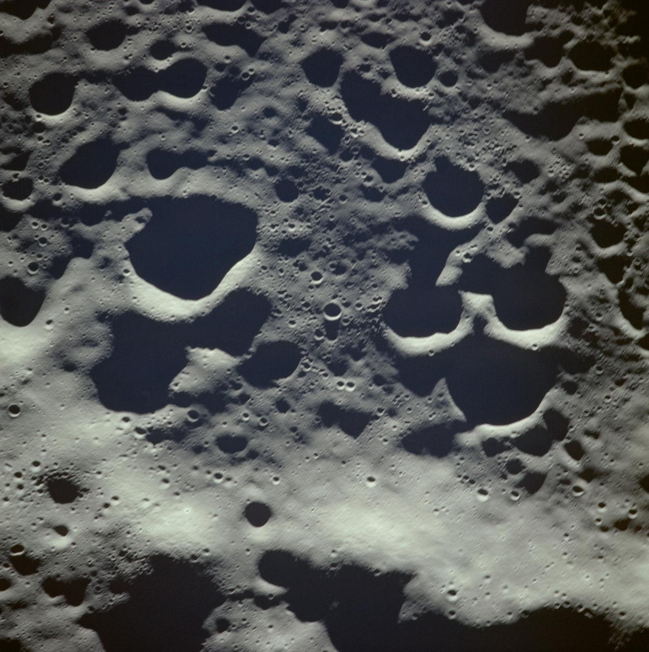 AS08-14-2400 (21-27 Dec. 1968) --- This near vertical photograph of the lunar surface taken with a telephoto lens during the Apollo 8 lunar orbit mission. The area covered by the photograph is approximately 20 miles on a side, and the photographed area is located at about 3 degrees south latitude and 160 degrees west longitude on the lunar farside. The lunar surface probably had less pronounced color than indicated by this print.