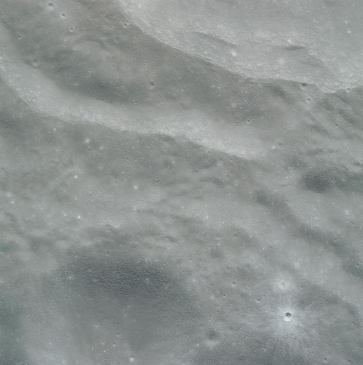 AS08-14-2432 (21-27 Dec. 1968) --- This is a near vertical photograph of the lunar surface taken with a telephoto lens during the Apollo 8 lunar orbit mission. The photographed area is approximately 20 miles on a side and is located within a large, unmanned 100-miles-in-diameter crater on the farside of the moon. This large crater is located at 10 degrees south latitude and 160 degrees east longitude. The lunar surface probably has less pronounced color then indicated by this print.