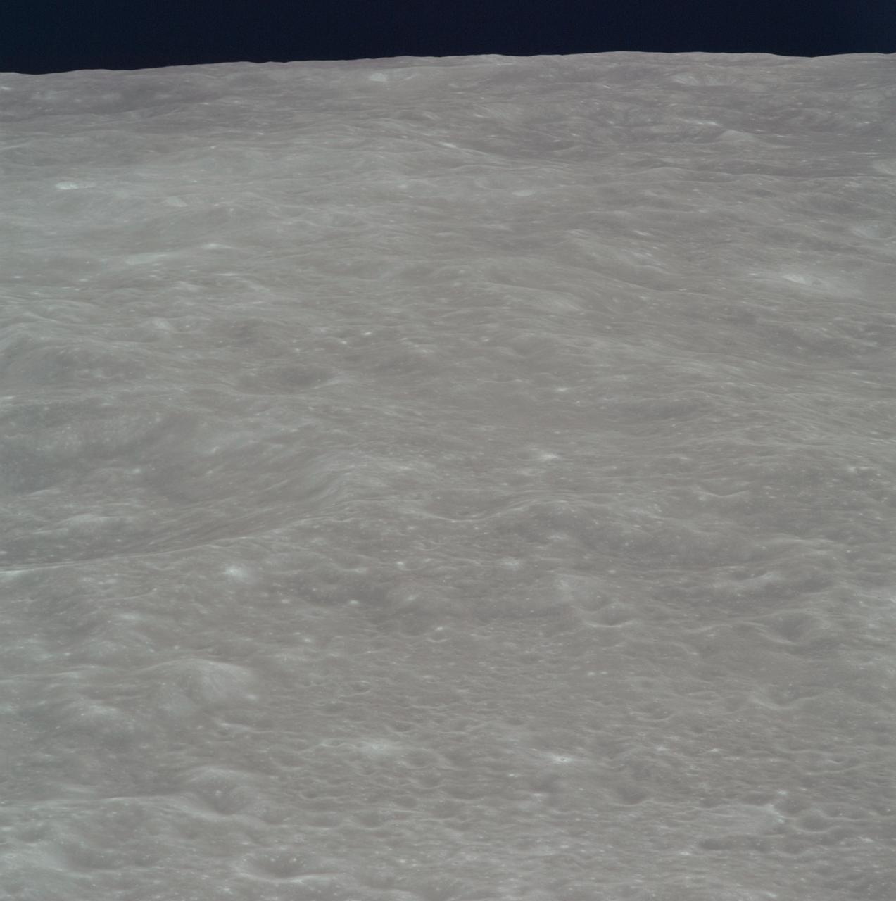 AS08-14-2446 (21-27 Dec. 1968) --- This is an oblique view of the lunar horizon looking southwest. This photograph, taken during the Apollo 8 lunar orbit mission, covers an area in the foreground to the northwest of the crater Tsiolkovsky on the lunar farside. The area in the foreground is located at about 15 degrees south latitude and 120 degrees east longitude. The lunar surface probably has less pronounced color than indicated by this print.