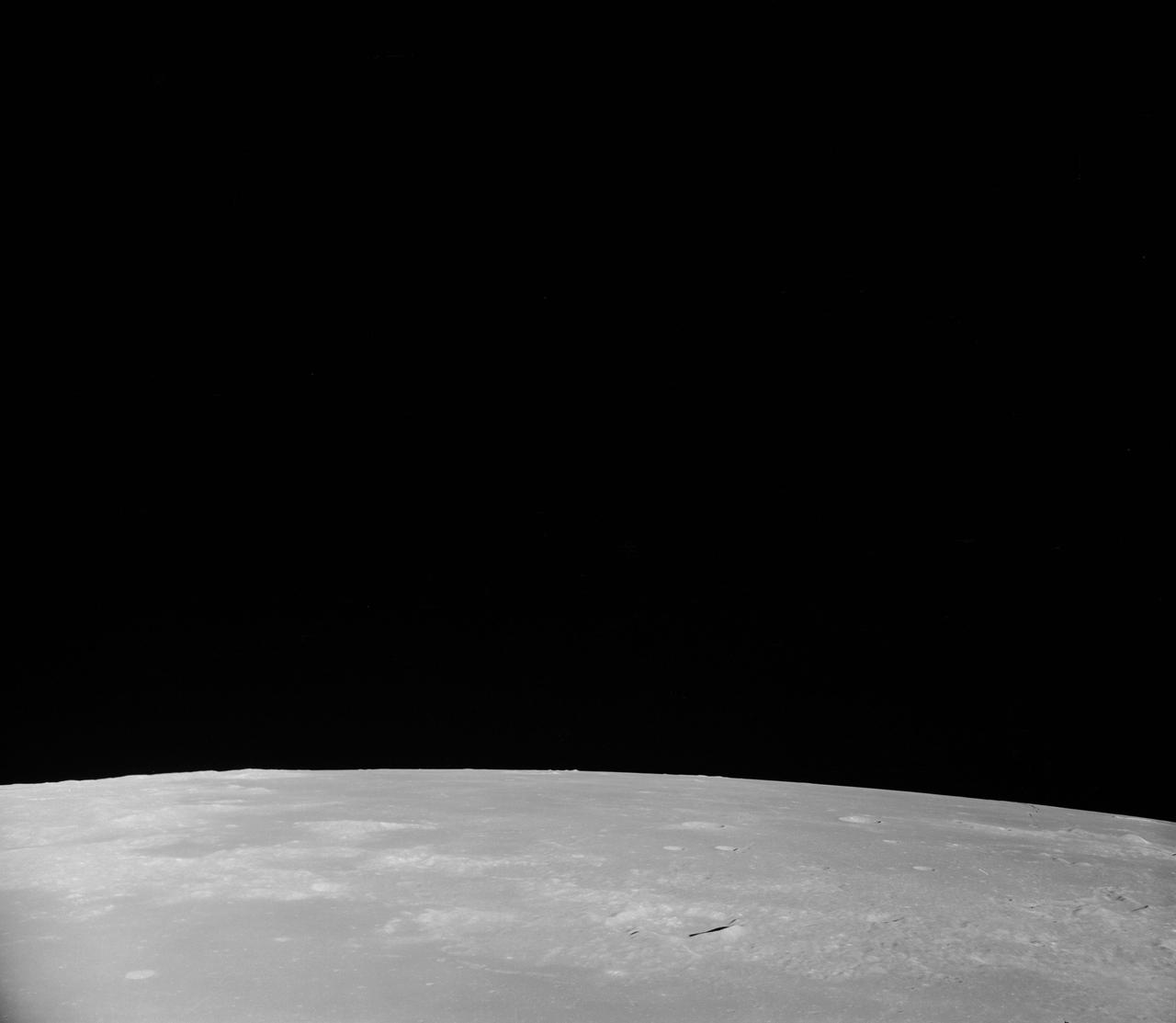 AS08-17-2814 (21-27 Dec. 1968) --- This oblique view of the lunar surface taken from the Apollo 8 spacecraft looking westward across the Sea of Fertility into the Sea of Tranquility shows the terrain the astronauts will see as the approach Apollo Landing Site East 2. The landing site is at the horizon about one-third of the distance from the left to the right photograph margin. The prominent crater in the highlands near the center of the picture is Secchi, about 25 kilometers (15 statute miles) in diameter.