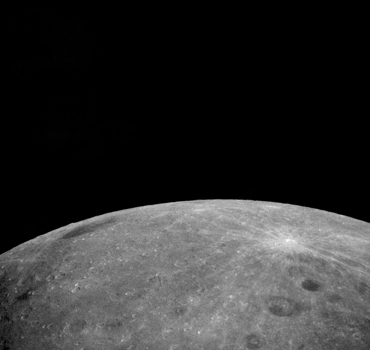 AS8-18-2883 (21-27 Dec. 1968) --- An Apollo 8 photograph of the surface of the moon. HOLD PICTURE WITH SKY AT TOP. The dark-floored crater in the lower right corner is named Lomonosov, and measures approximately 50 statute miles in diameter. The bright-rayed crater was named Giordano Bruno by the Russians. Bruno was a sixteenth-century Italian scientist. Lomonosov is located on the lunar farside at about 102 degrees east longitude and 28 degrees north latitude.