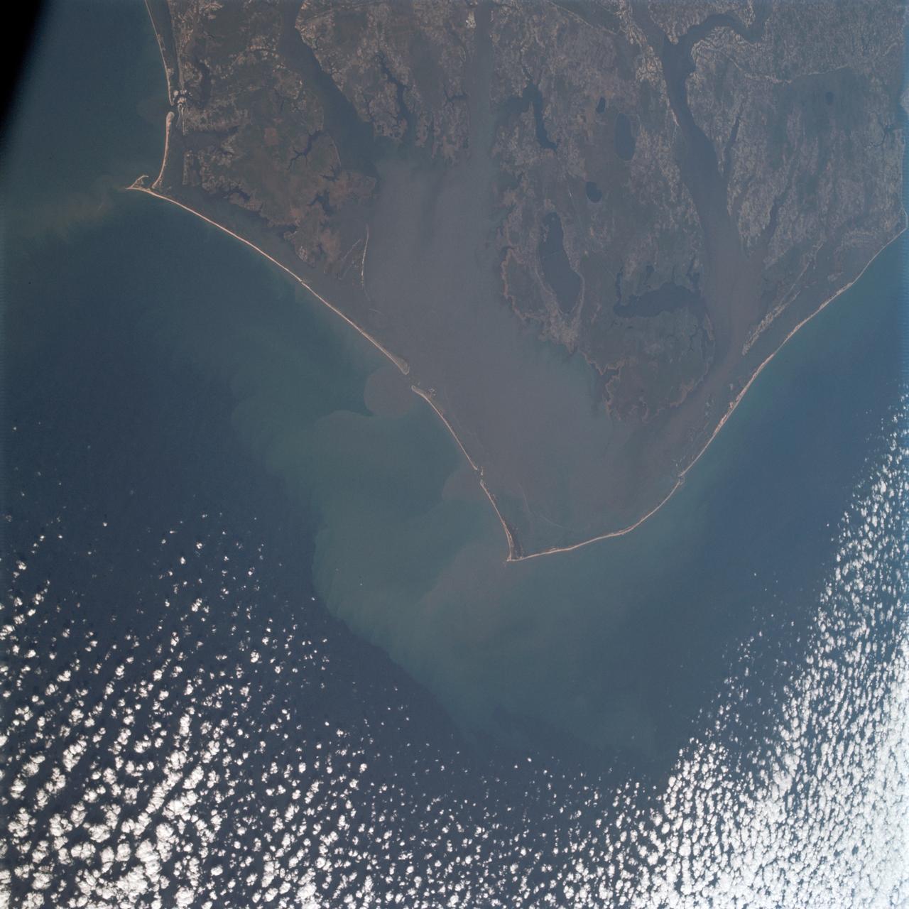 AS09-20-3128 (3-13 March 1969) --- Cape Hatteras, North Carolina, area as photographed from the Apollo 9 spacecraft during its Earth-orbital mission. Cape Lookout is near bottom of picture. Cape Hatteras juts the farthest out into the Atlantic. Largest inland body of water is Pamlico Sound; and to the north of it is Albemarle Sound.